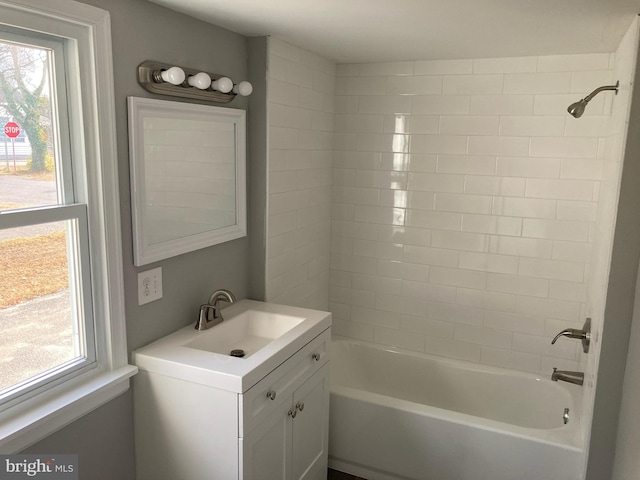 bathroom featuring vanity and tiled shower / bath