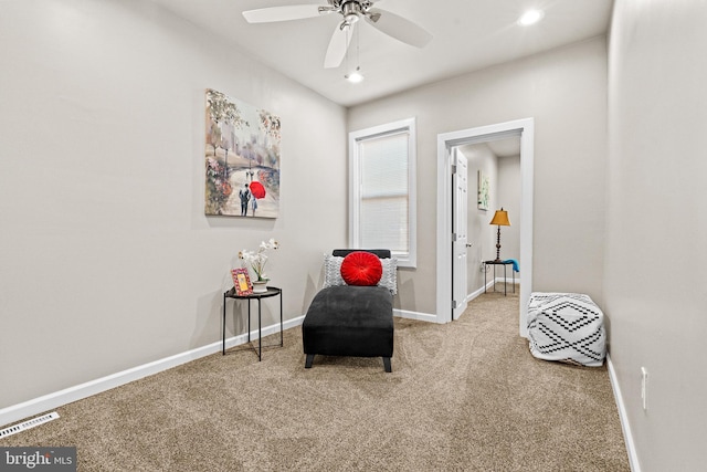 sitting room with carpet flooring and ceiling fan