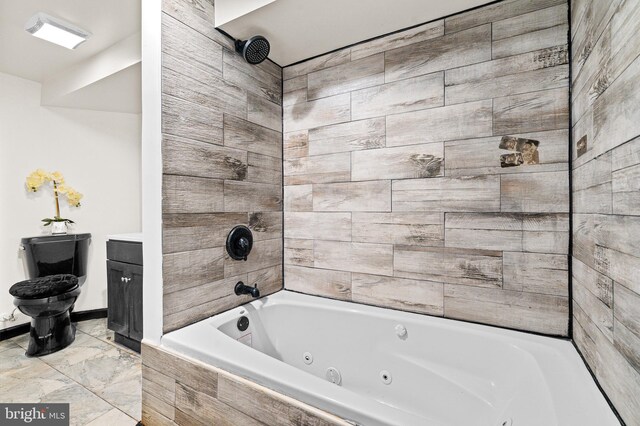 bathroom featuring vanity and tiled shower / bath