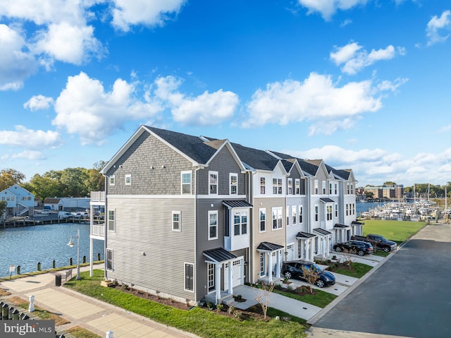 exterior space featuring a garage and a water view