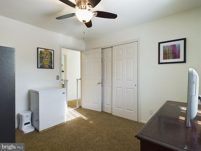 office featuring ceiling fan and dark colored carpet