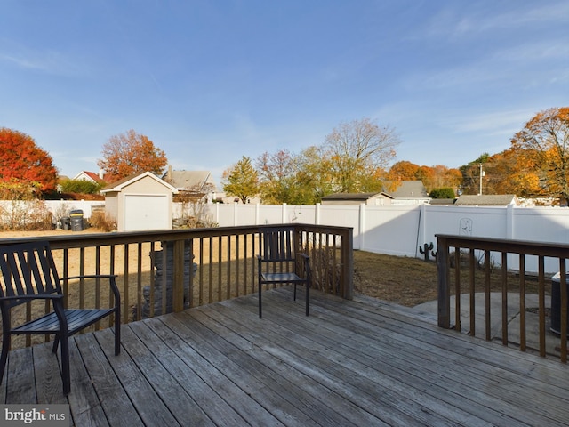 wooden deck with a storage shed