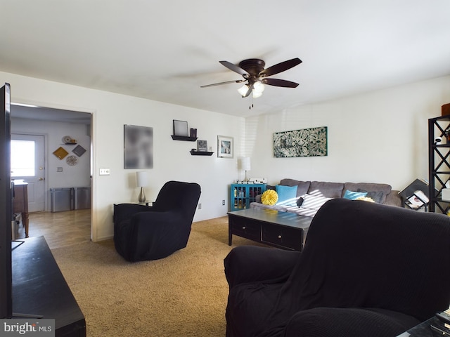 living room featuring carpet flooring and ceiling fan