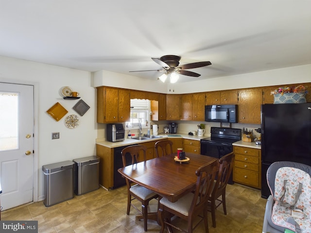 kitchen with a wealth of natural light, sink, ceiling fan, and black appliances