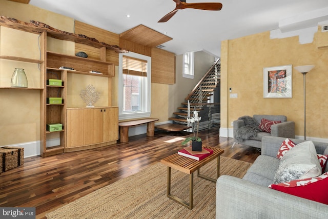 living room featuring dark hardwood / wood-style floors and ceiling fan