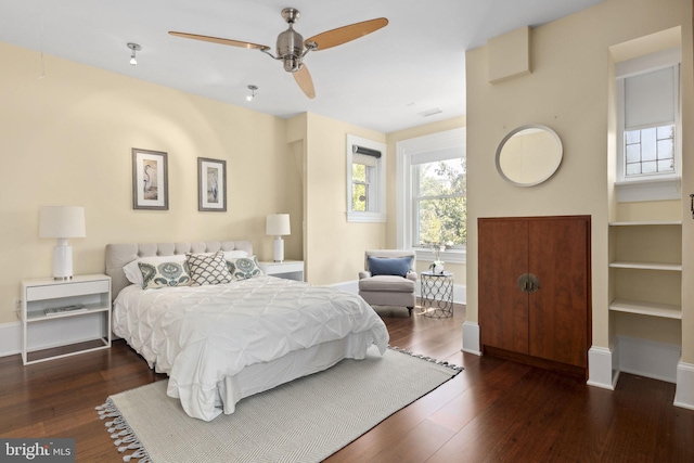 bedroom with dark hardwood / wood-style floors and ceiling fan