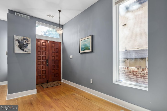 foyer with a notable chandelier and light wood-type flooring