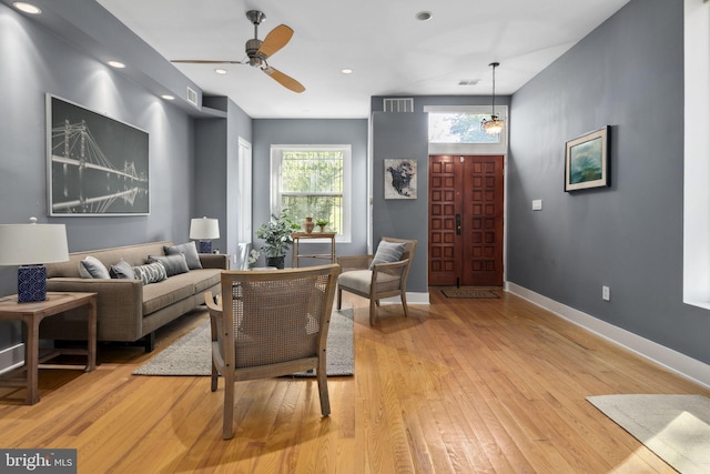 living room with ceiling fan and light hardwood / wood-style floors