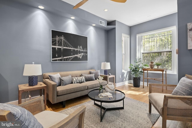 living room featuring ceiling fan and light wood-type flooring