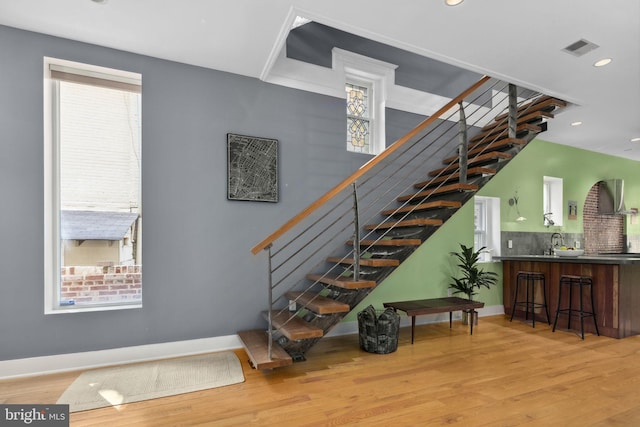 stairs featuring hardwood / wood-style floors