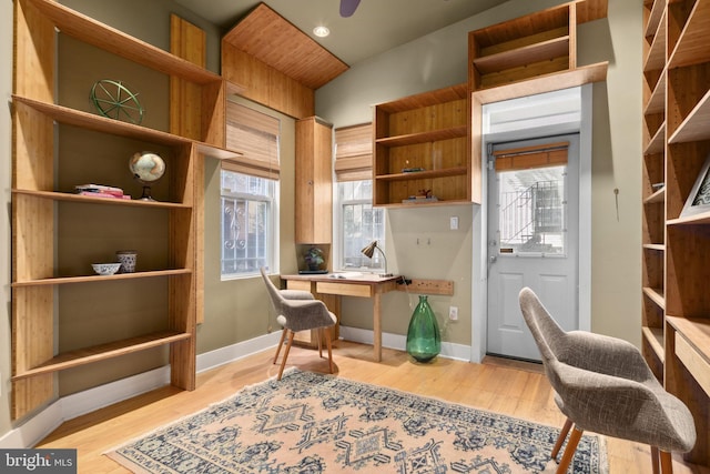 home office featuring light hardwood / wood-style flooring and lofted ceiling