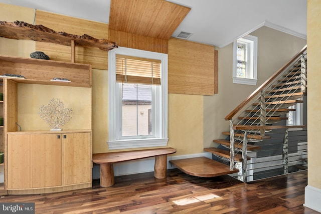 stairs with hardwood / wood-style floors and ornamental molding