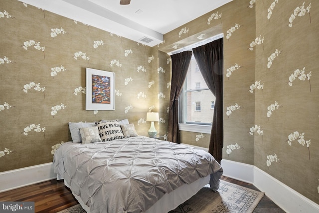 bedroom with dark hardwood / wood-style flooring and ceiling fan