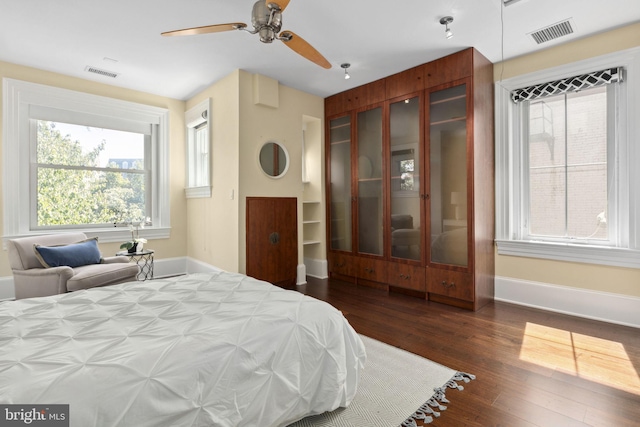 bedroom with ceiling fan, a closet, and dark wood-type flooring