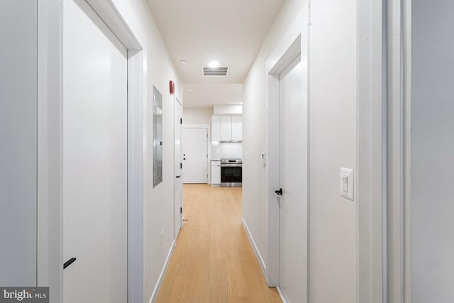 hall with light hardwood / wood-style flooring