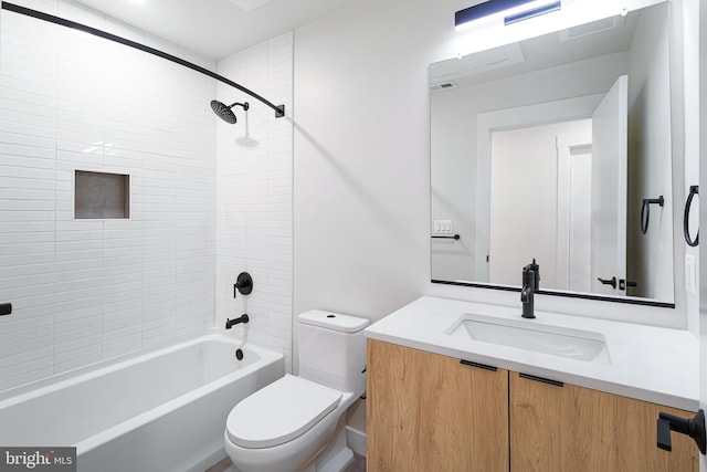 full bathroom featuring toilet, vanity, and tiled shower / bath combo