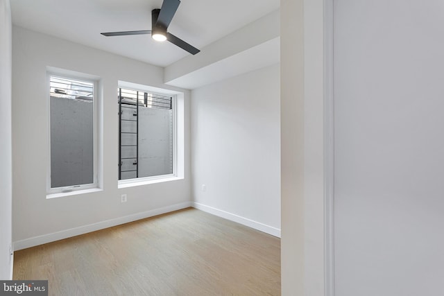 empty room featuring light wood-type flooring and ceiling fan