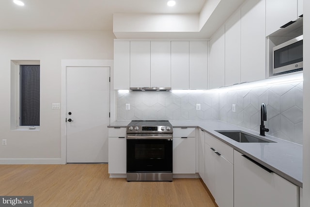 kitchen with white cabinets, sink, and stainless steel appliances