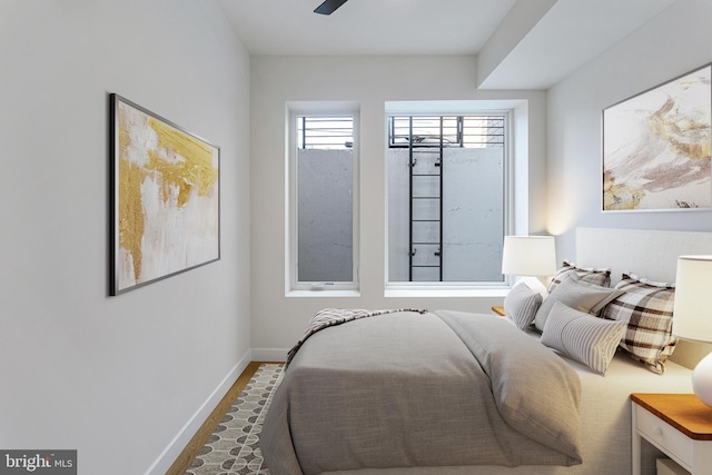 bedroom featuring hardwood / wood-style flooring and ceiling fan