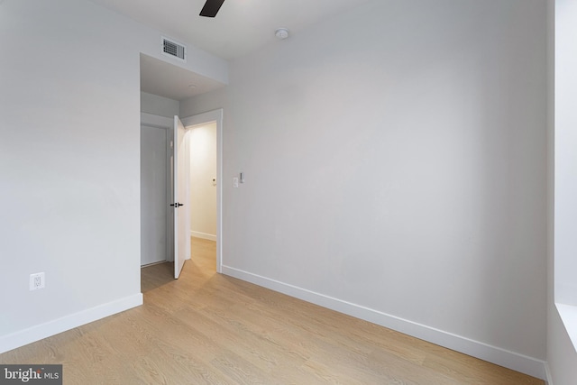 empty room with light hardwood / wood-style flooring and ceiling fan