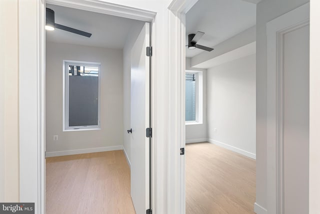 corridor with light hardwood / wood-style floors