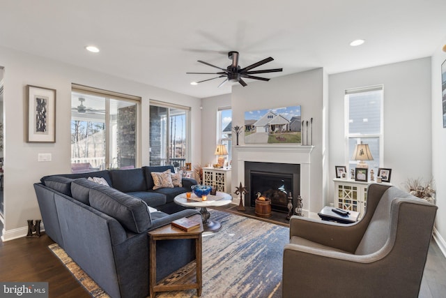 living room with dark hardwood / wood-style flooring and ceiling fan