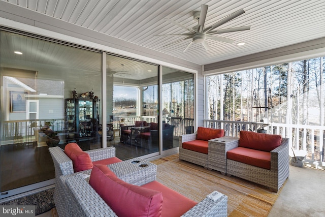 sunroom with ceiling fan, a healthy amount of sunlight, and wooden ceiling