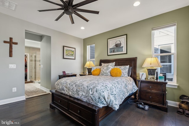 bedroom featuring ceiling fan, dark hardwood / wood-style floors, and connected bathroom