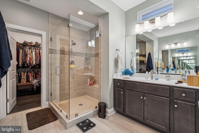 bathroom featuring tile patterned floors, vanity, and a shower with shower door