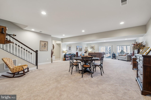 dining area featuring light carpet