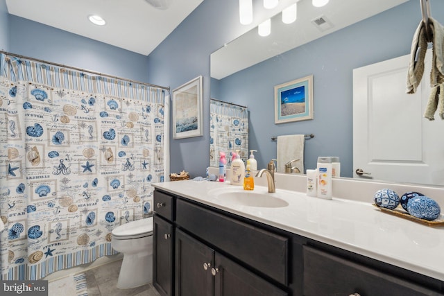 bathroom with tile patterned flooring, vanity, curtained shower, and toilet