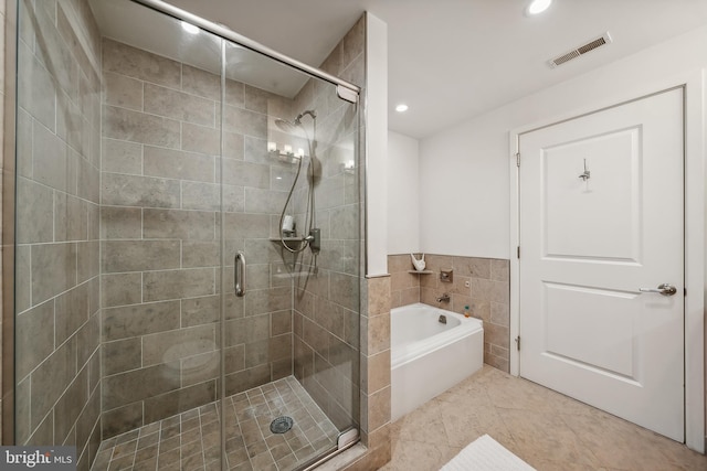 bathroom with tile patterned flooring and separate shower and tub