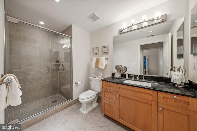 bathroom with toilet, tile patterned flooring, a shower with shower door, and vanity