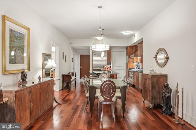 dining area with dark hardwood / wood-style floors