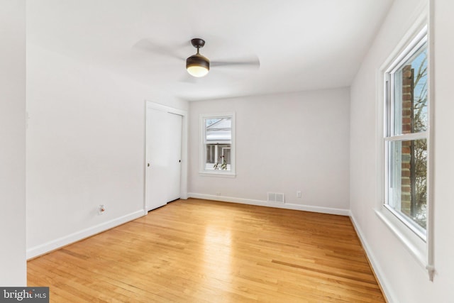 empty room with light wood-type flooring and ceiling fan