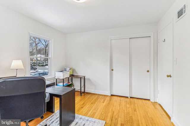 home office with hardwood / wood-style floors