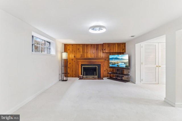 living room featuring light colored carpet and wood walls