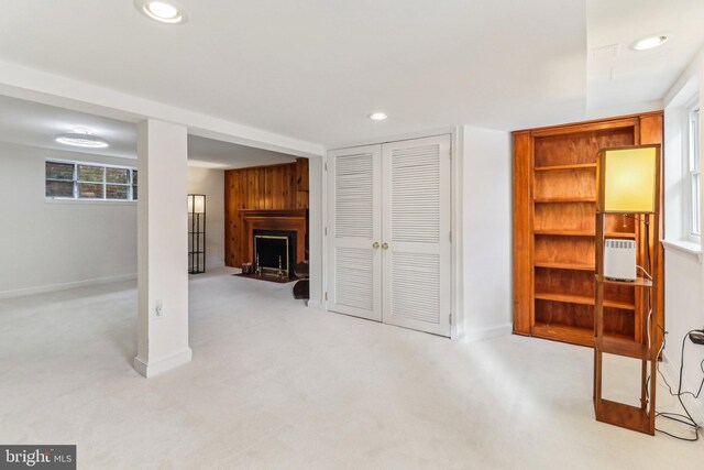 unfurnished living room with a fireplace and light carpet