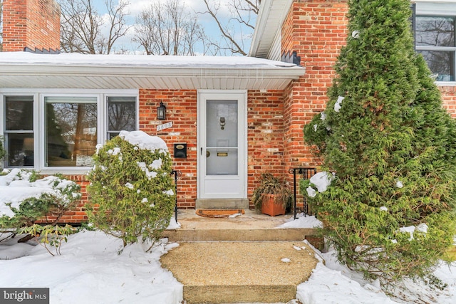 view of snow covered property entrance