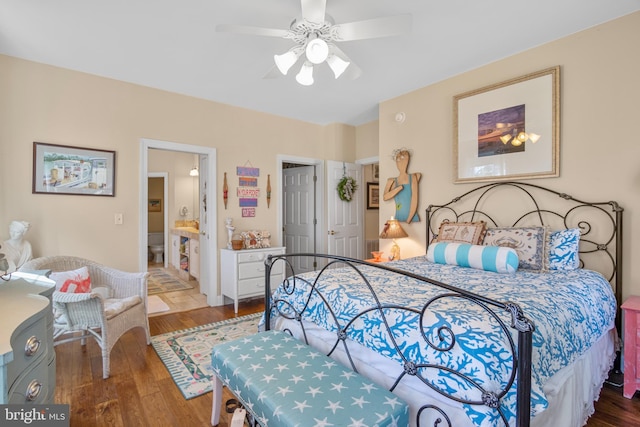 bedroom with hardwood / wood-style flooring, ensuite bath, and ceiling fan