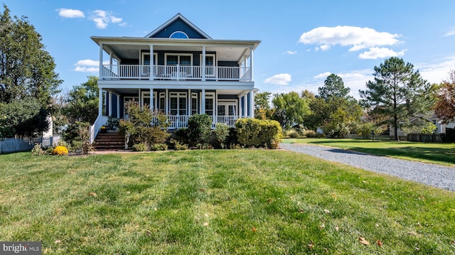 view of front of property with a porch, a balcony, and a front yard