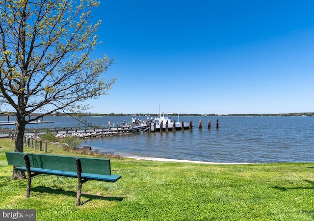 view of dock featuring a water view and a lawn