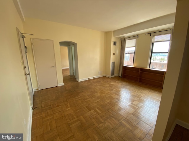 spare room featuring parquet flooring