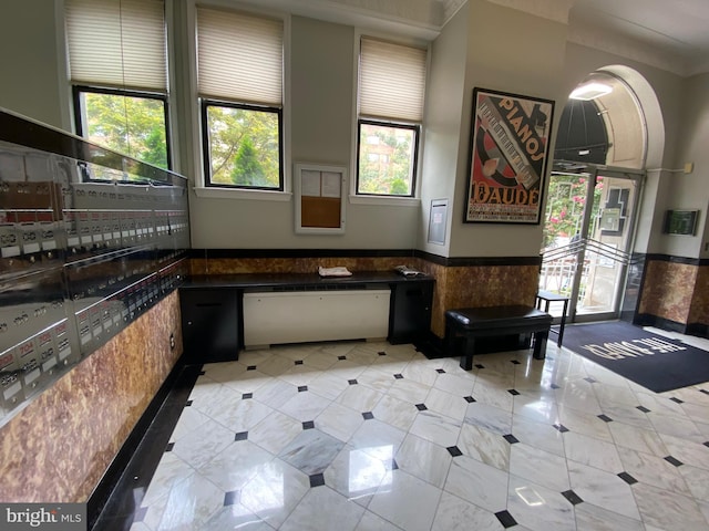 interior space featuring tile walls and a healthy amount of sunlight