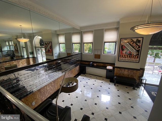 interior space featuring decorative light fixtures and ornamental molding