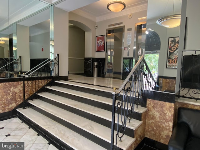 stairway with elevator and ornamental molding