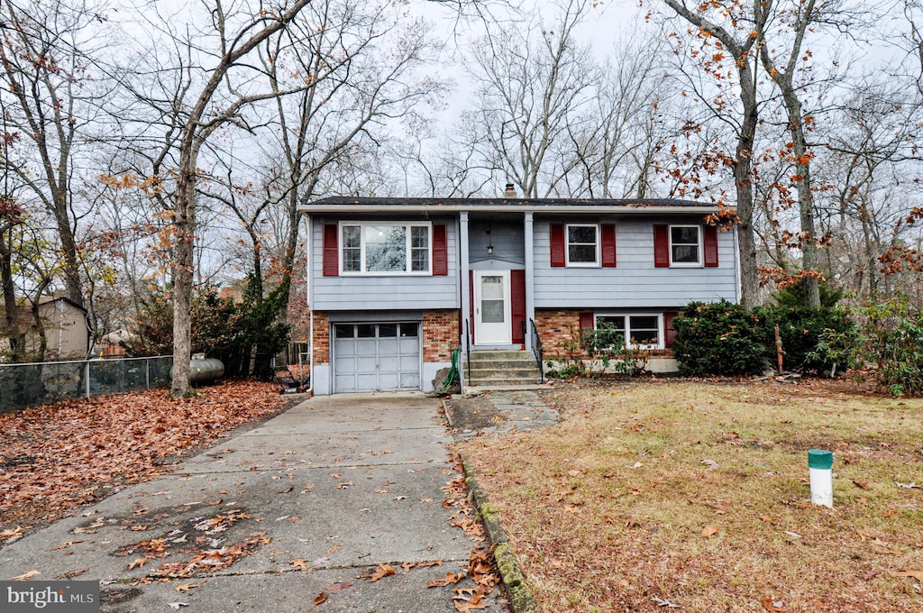 bi-level home featuring a front yard and a garage