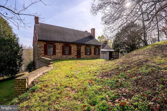 rear view of house featuring a yard