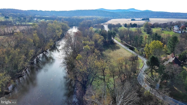 drone / aerial view featuring a water and mountain view