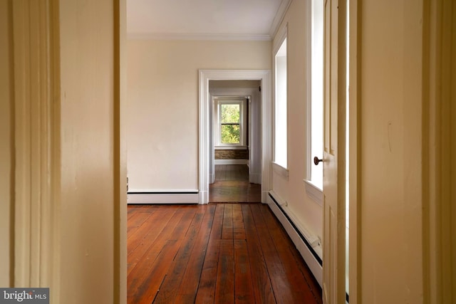 hall featuring dark hardwood / wood-style floors, crown molding, and a baseboard heating unit